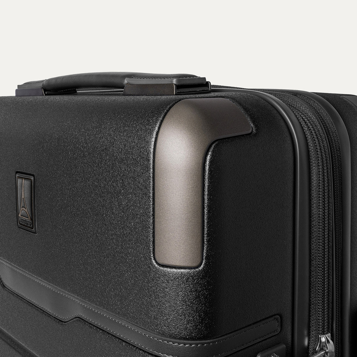 Close-up of the zinc corner armor on the Travelpro Platinum Reserve Compact Carry-On Hardside Spinner in Black Dust