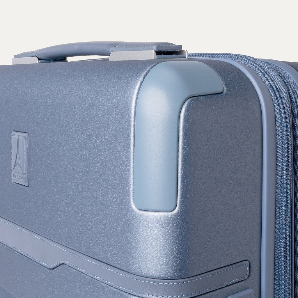 Close-up of the zinc corner armor on the Travelpro Platinum Reserve Compact Carry-On Hardside Spinner in Steel Blue