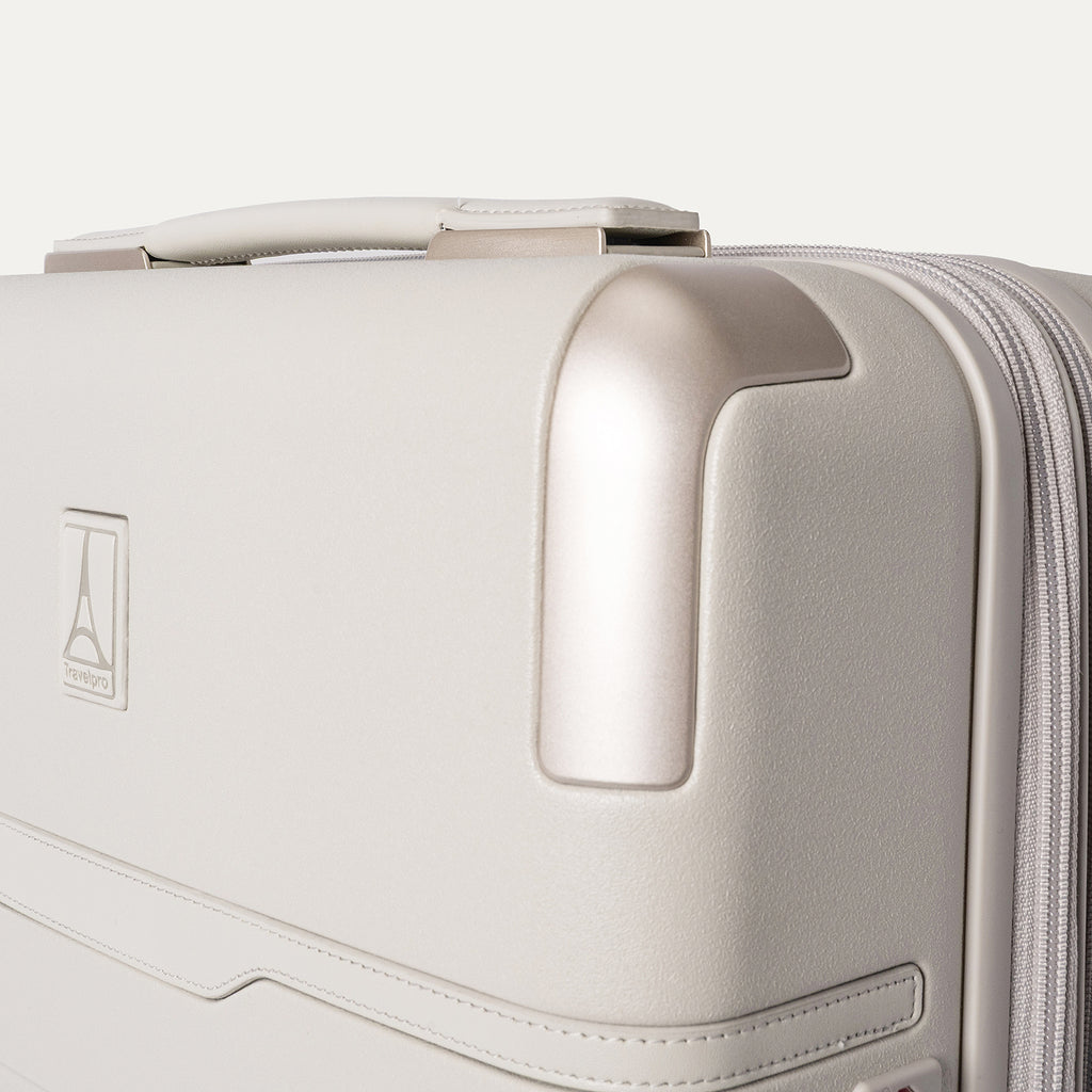 Close-up of the zinc corner armor on the Travelpro Platinum Reserve Compact Carry-On Hardside Spinner in Sandstone