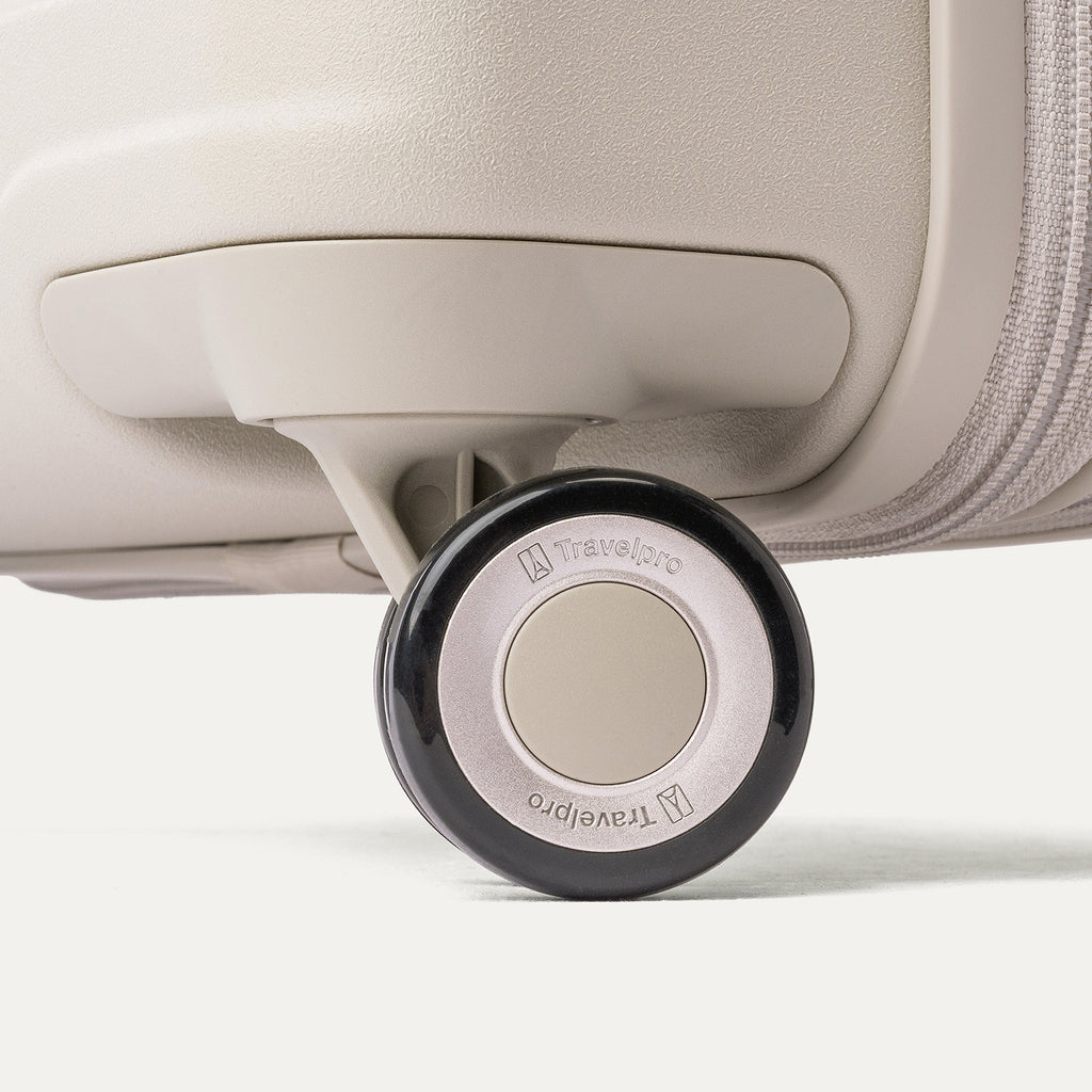 Close-up of a MagnaTrac self-aligning spinner wheel on the Travelpro Platinum Reserve Compact Carry-On Hardside Spinner in Sandstone