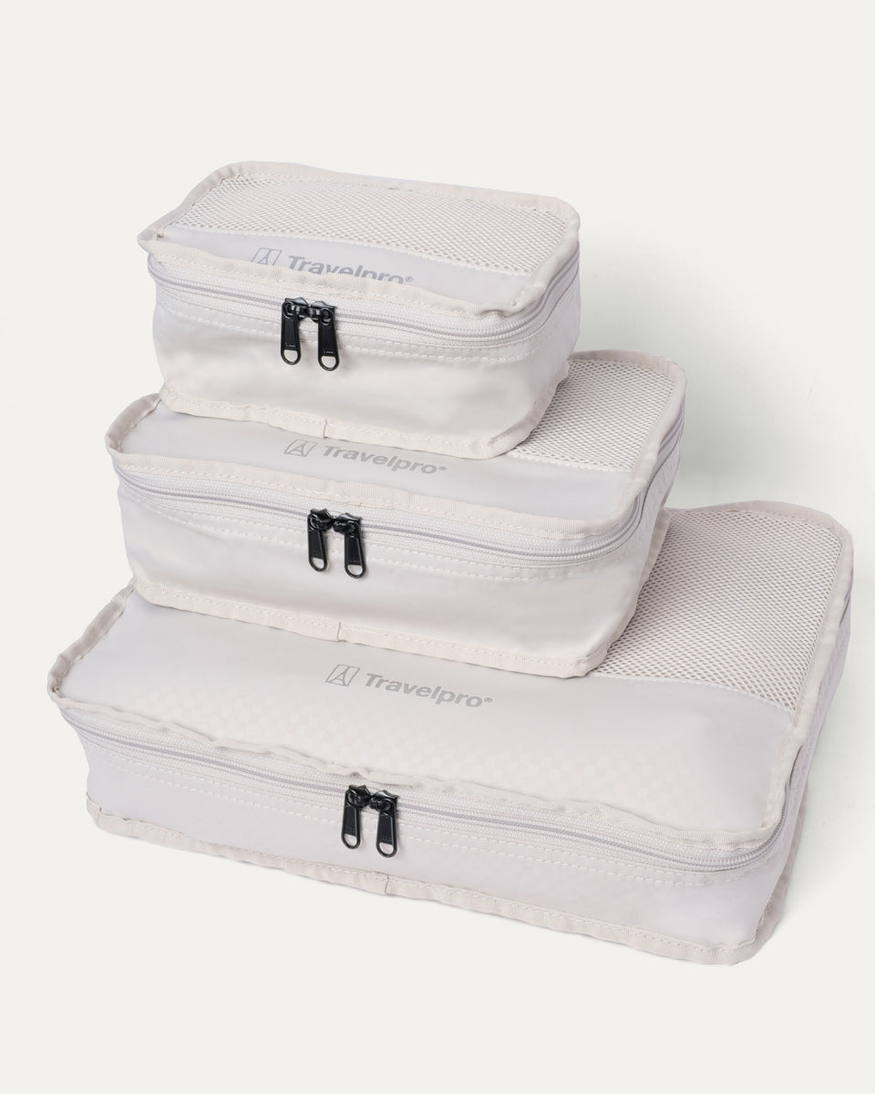 Packing cubes included with the Travelpro Platinum Reserve Compact Carry-On Hardside Spinner in Midnight Trail, stacked by size