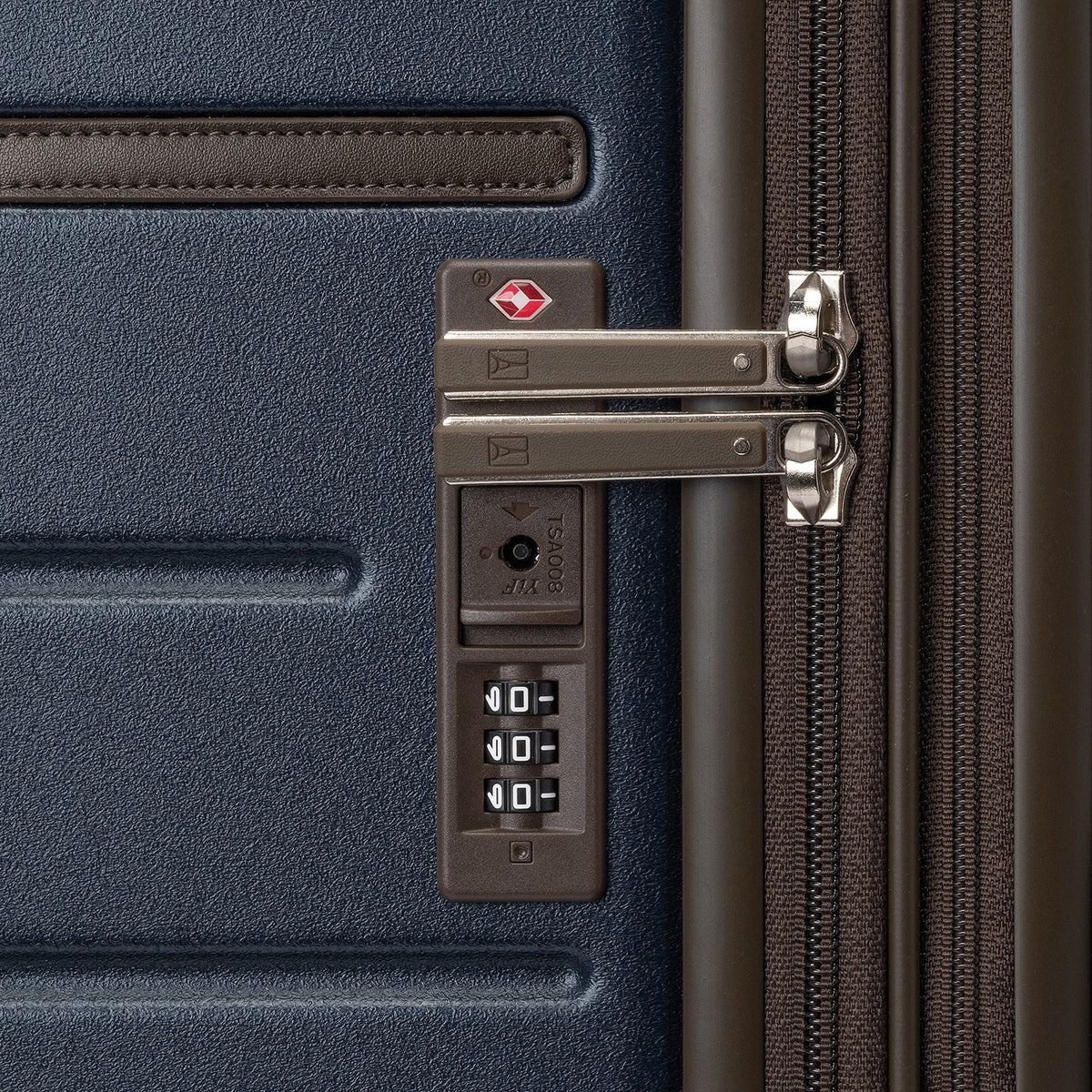 Close-up of the built-in TSA lock on the Travelpro Platinum Reserve Compact Carry-On Hardside Spinner in Midnight Trail