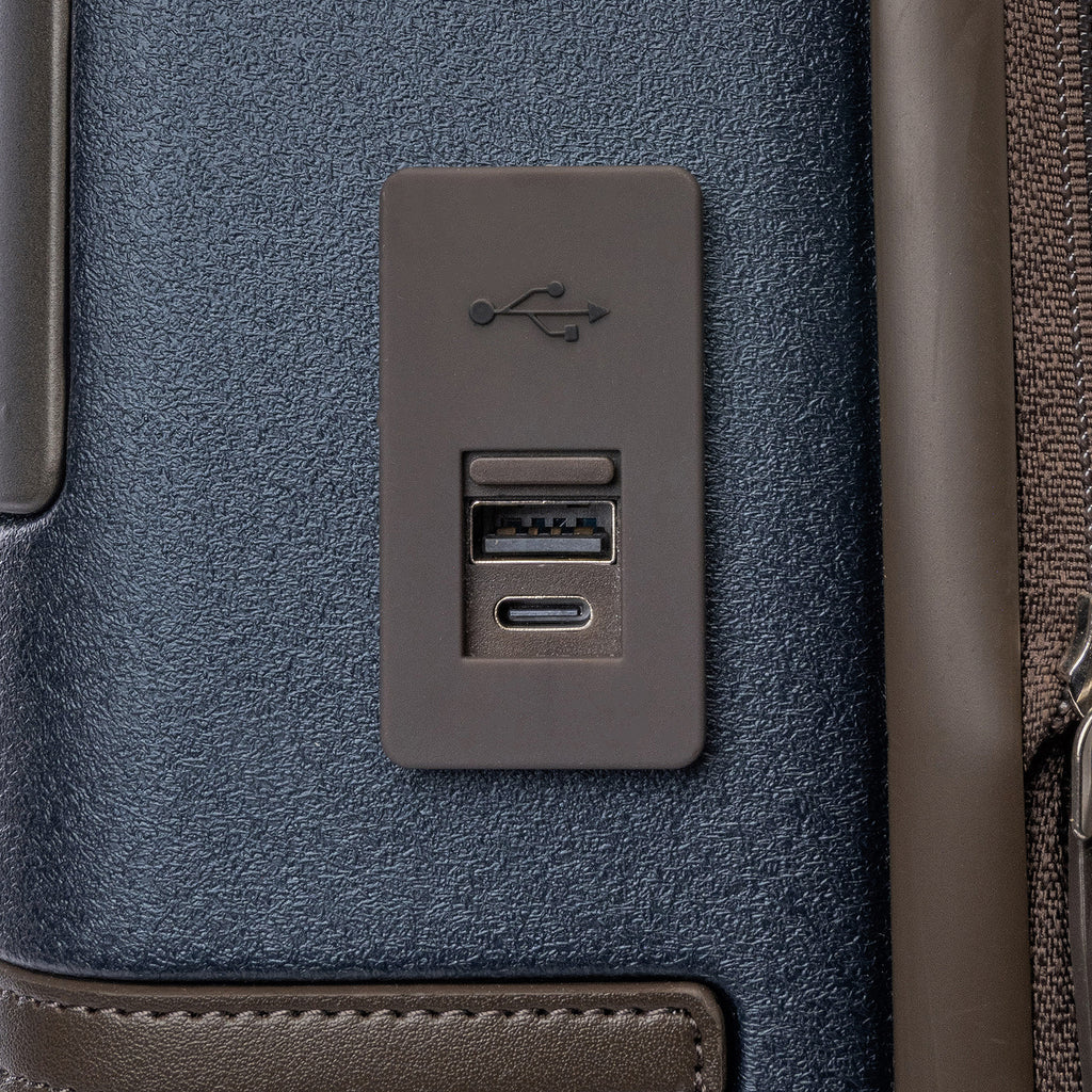 Close-up of the external USB-A and USB-C charging ports on the Travelpro Platinum Reserve Compact Carry-On Hardside Spinner in Midnight Trail
