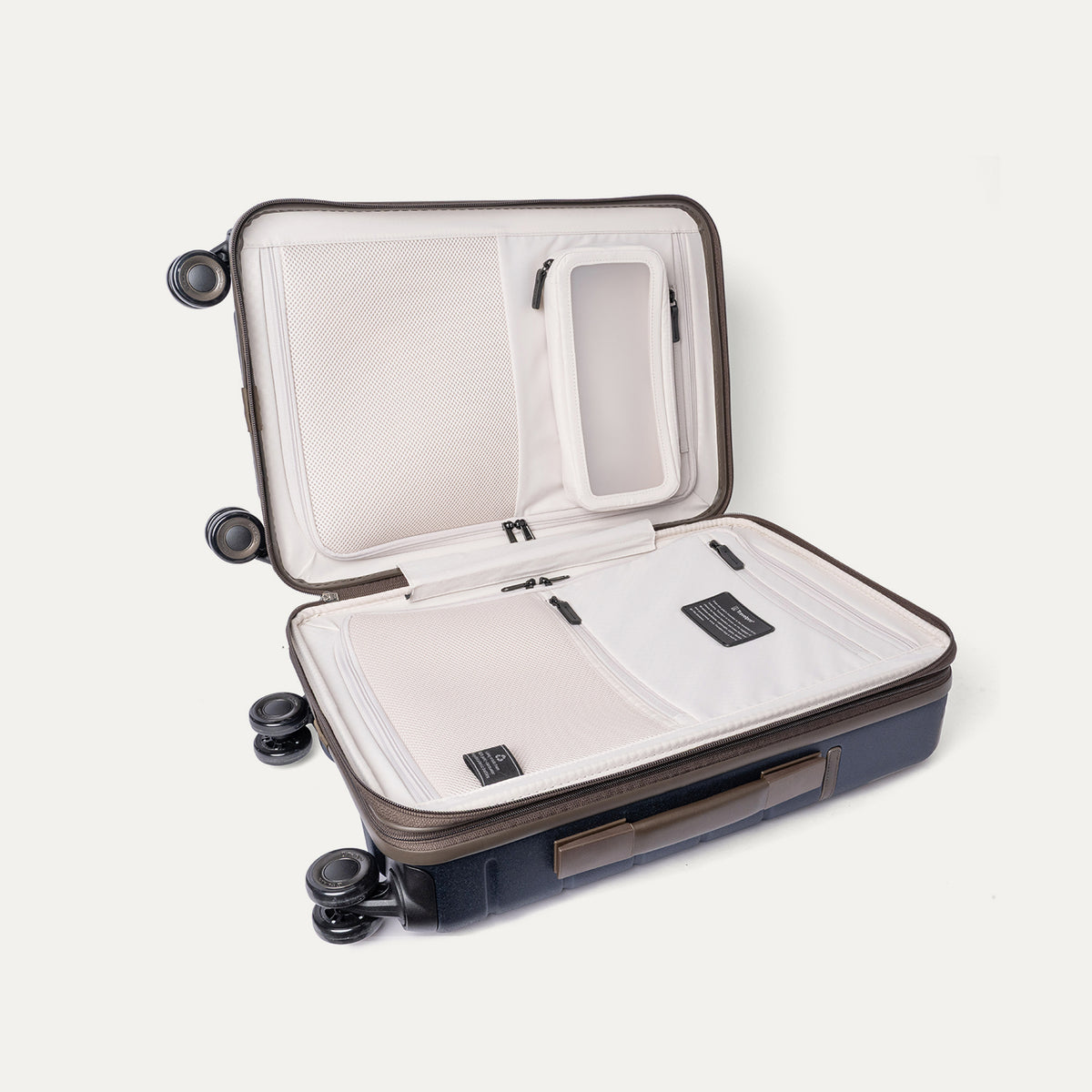 Open interior of the Travelpro Platinum Reserve Compact Carry-On Hardside Spinner in Midnight Trail showing the zippered divider panel and dedicated pockets