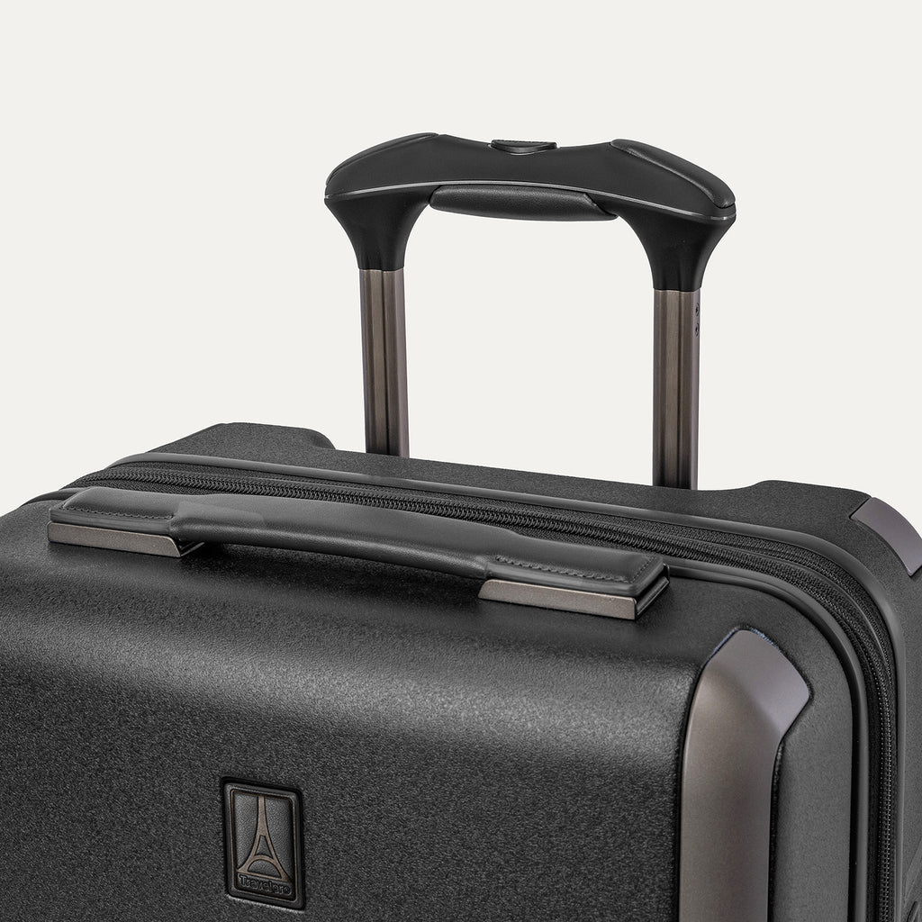 Close-up of the leather-wrapped top handle and PowerScope Lite extension handle on the Travelpro Platinum Reserve Carry-On Hardside Spinner in Black Dust
