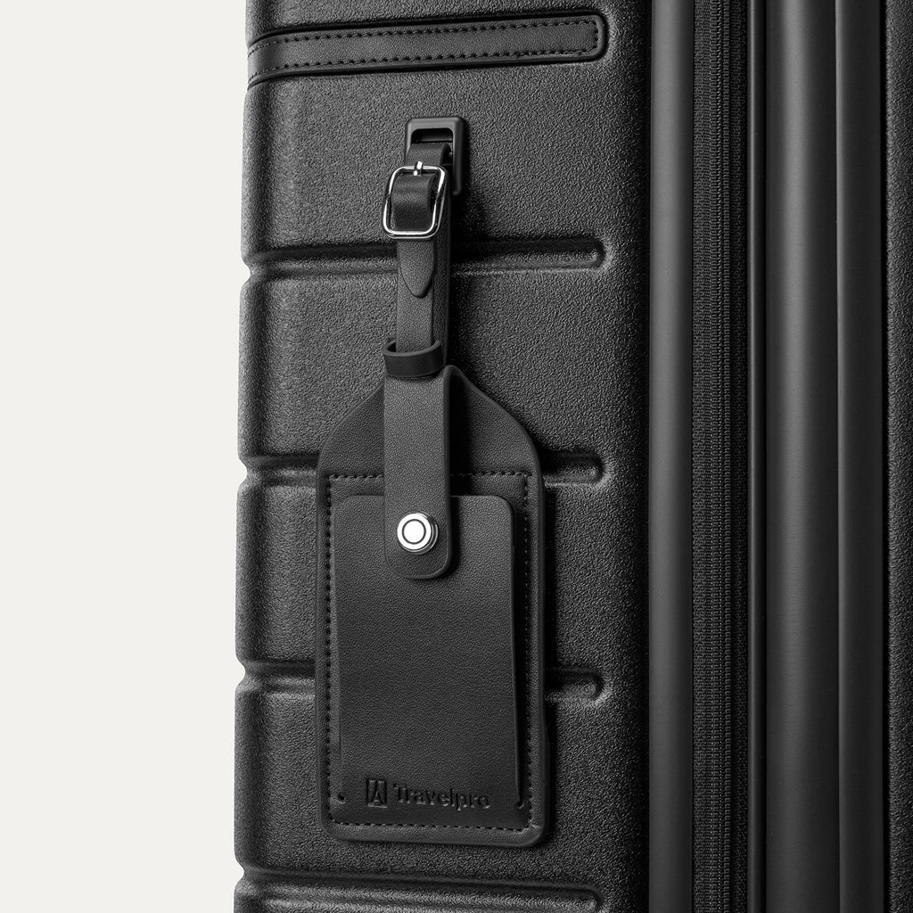 Close-up of the full-grain leather luggage tag on the Travelpro Platinum Reserve Carry-On Hardside Spinner in Black Dust