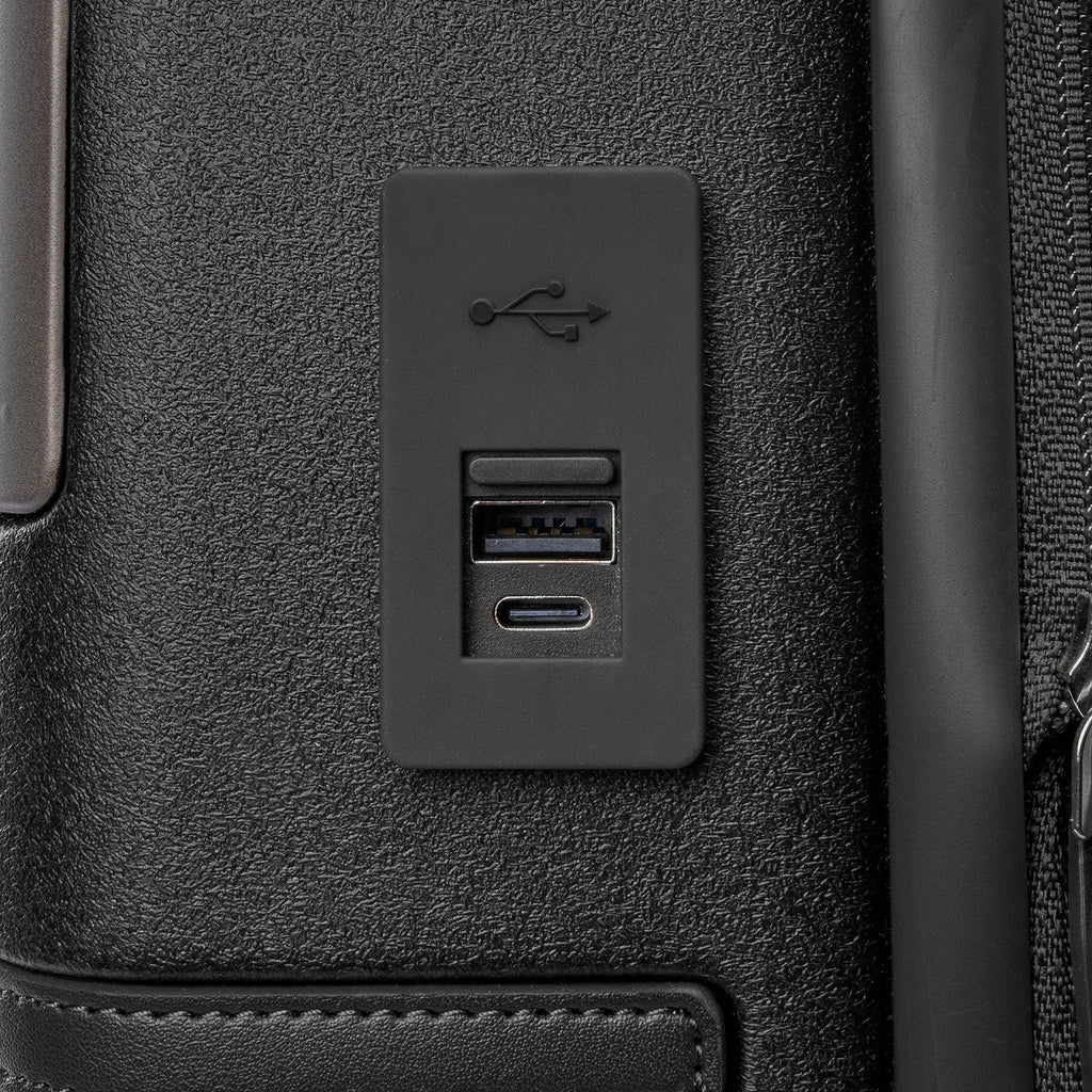Close-up of the external USB-A and USB-C charging ports on the Travelpro Platinum Reserve Carry-On Hardside Spinner in Black Dust