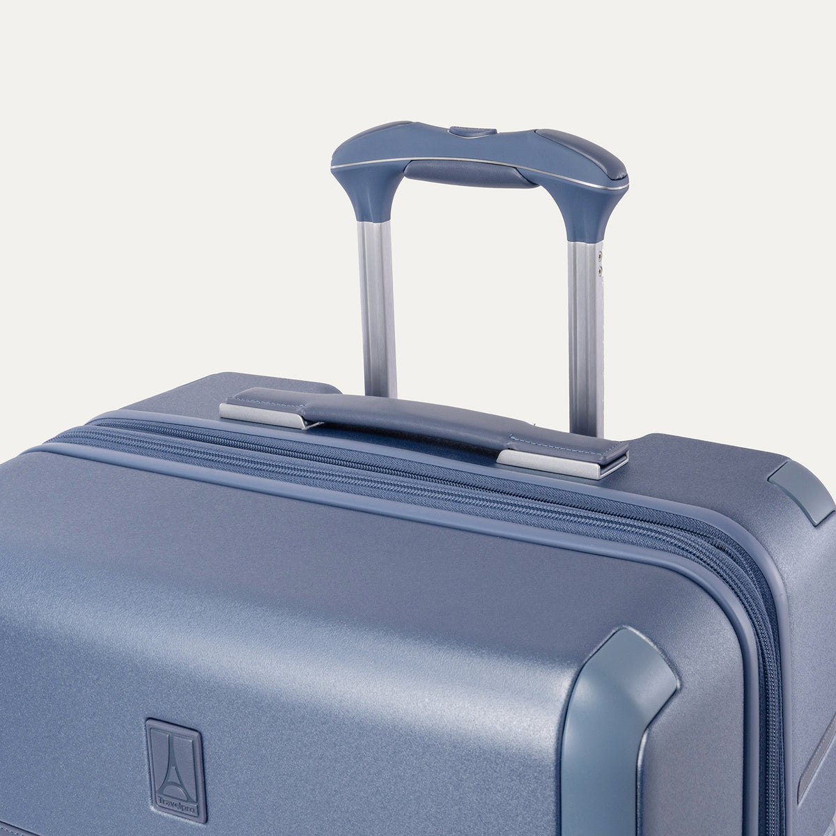 Close-up of the leather-wrapped top handle and PowerScope Lite extension handle on the Travelpro Platinum Reserve Carry-On Hardside Spinner in Steel Blue