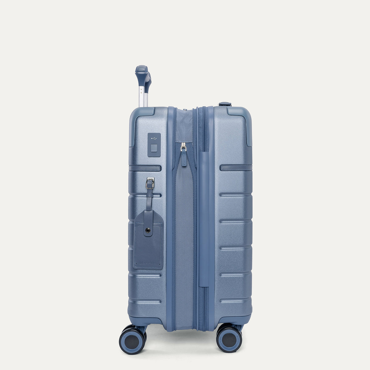 Side profile of the Travelpro Platinum Reserve Carry-On Hardside Spinner in Steel Blue, expanded for extra packing space