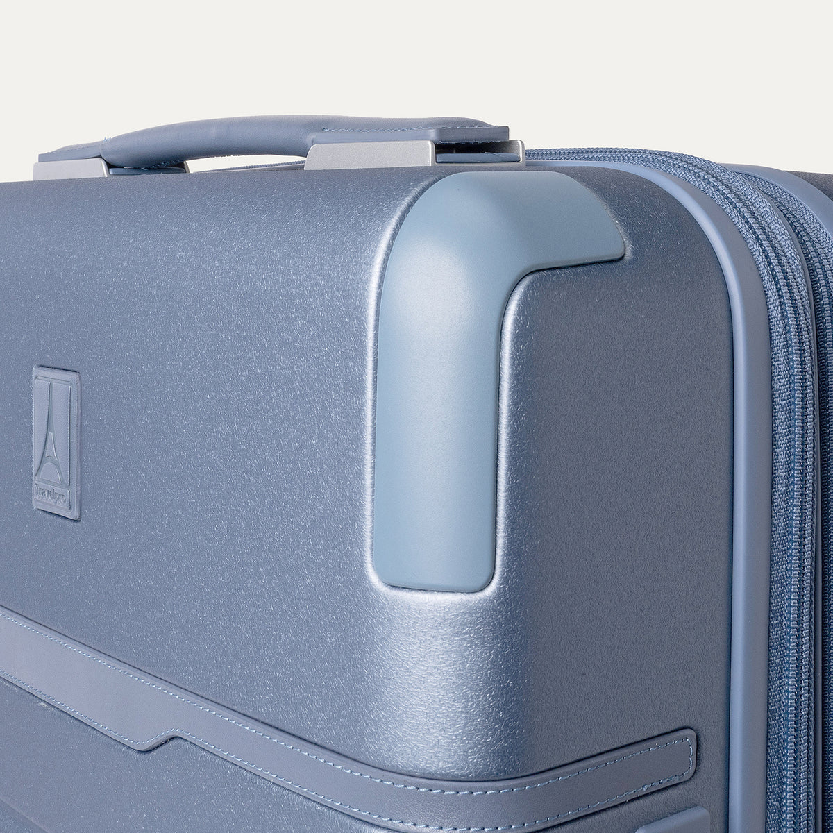 Close-up of the zinc corner armor on the Travelpro Platinum Reserve Carry-On Hardside Spinner in Steel Blue
