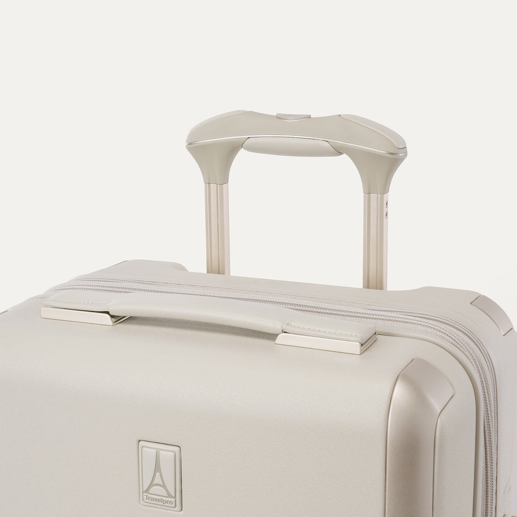 Close-up of the leather-wrapped top handle and PowerScope Lite extension handle on the Travelpro Platinum Reserve Carry-On Hardside Spinner in Sandstone