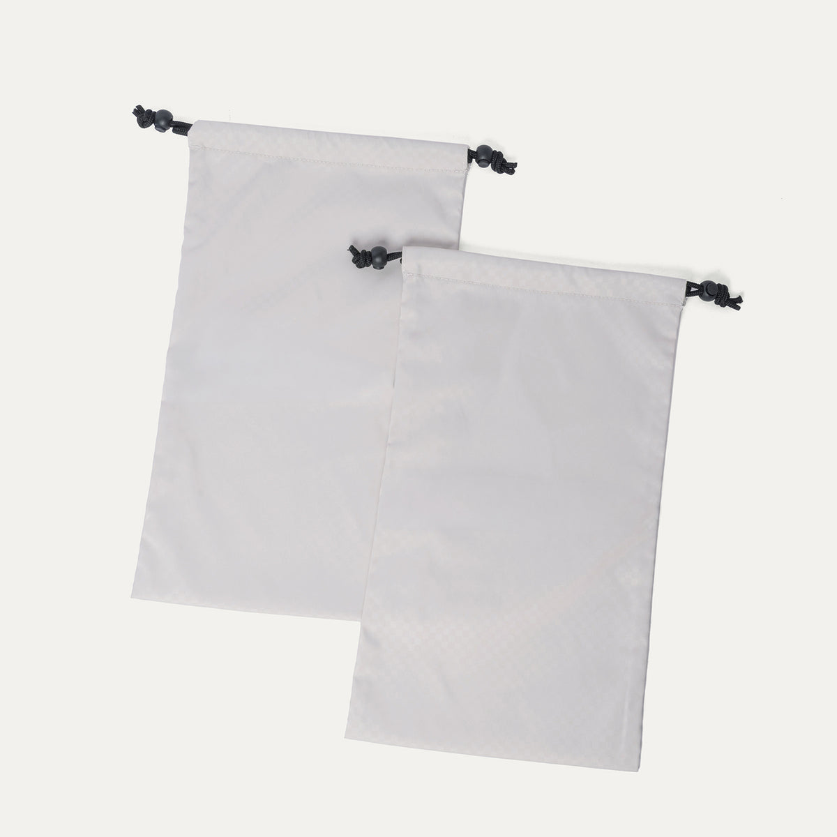 Removable drawstring shoe bags included with the Travelpro Platinum Reserve Carry-On Hardside Spinner in Sandstone