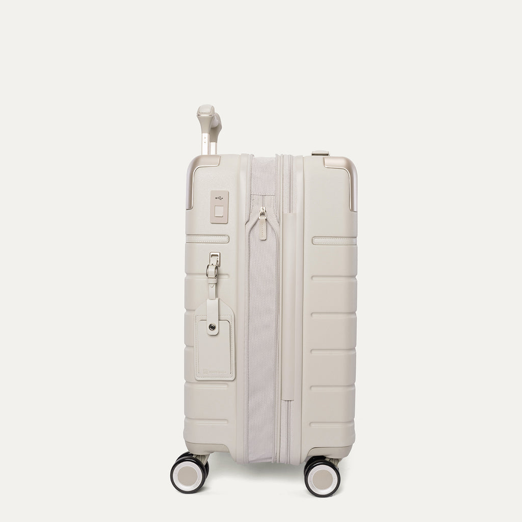 Side profile of the Travelpro Platinum Reserve Carry-On Hardside Spinner in Sandstone, expanded for extra packing space