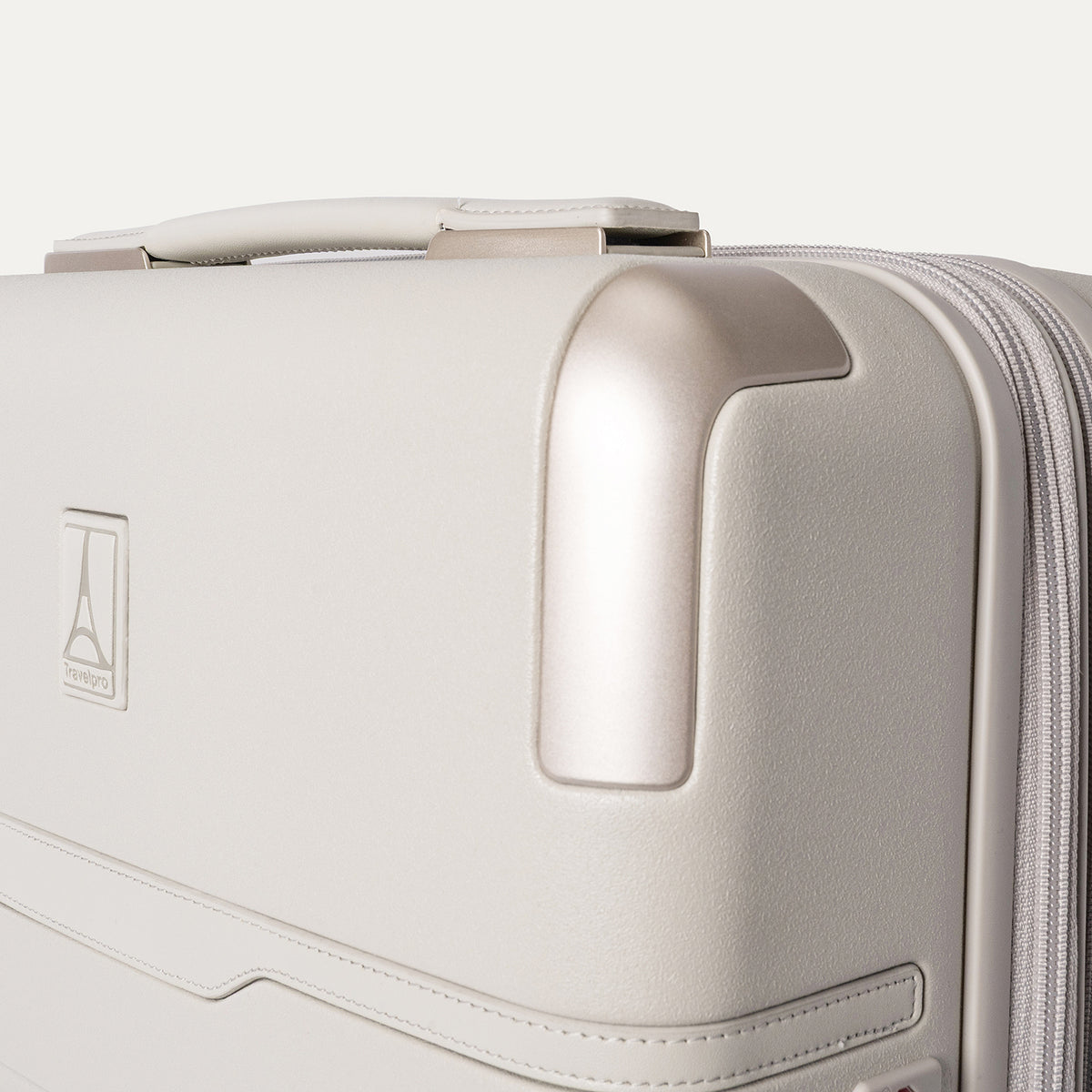 Close-up of the zinc corner armor on the Travelpro Platinum Reserve Carry-On Hardside Spinner in Sandstone