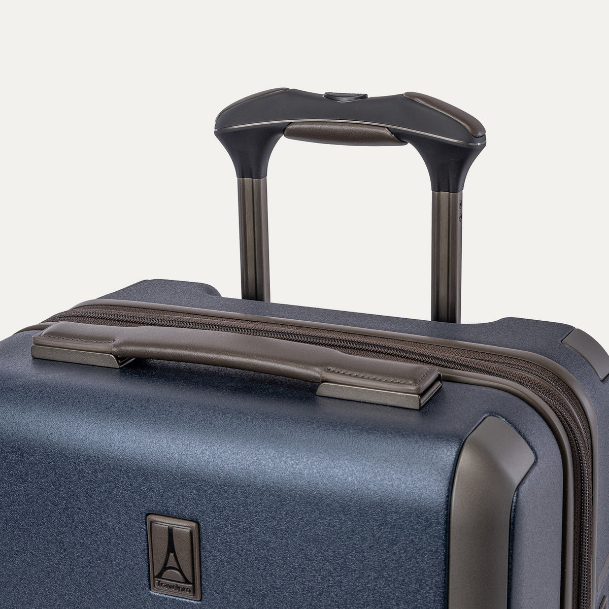 Close-up of the leather-wrapped top handle and PowerScope Lite extension handle on the Travelpro Platinum Reserve Carry-On Hardside Spinner in Midnight Trail