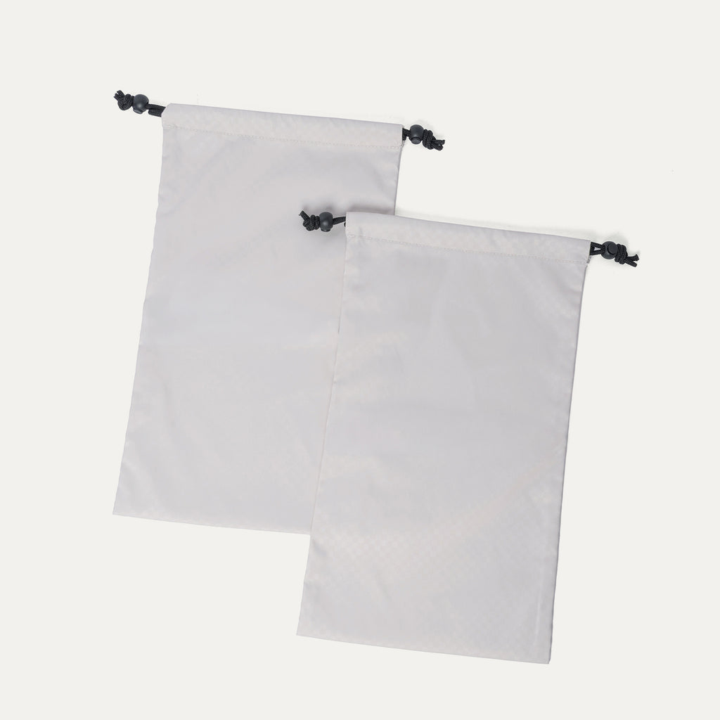 Removable drawstring shoe bags included with the Travelpro Platinum Reserve Carry-On Hardside Spinner in Midnight Trail