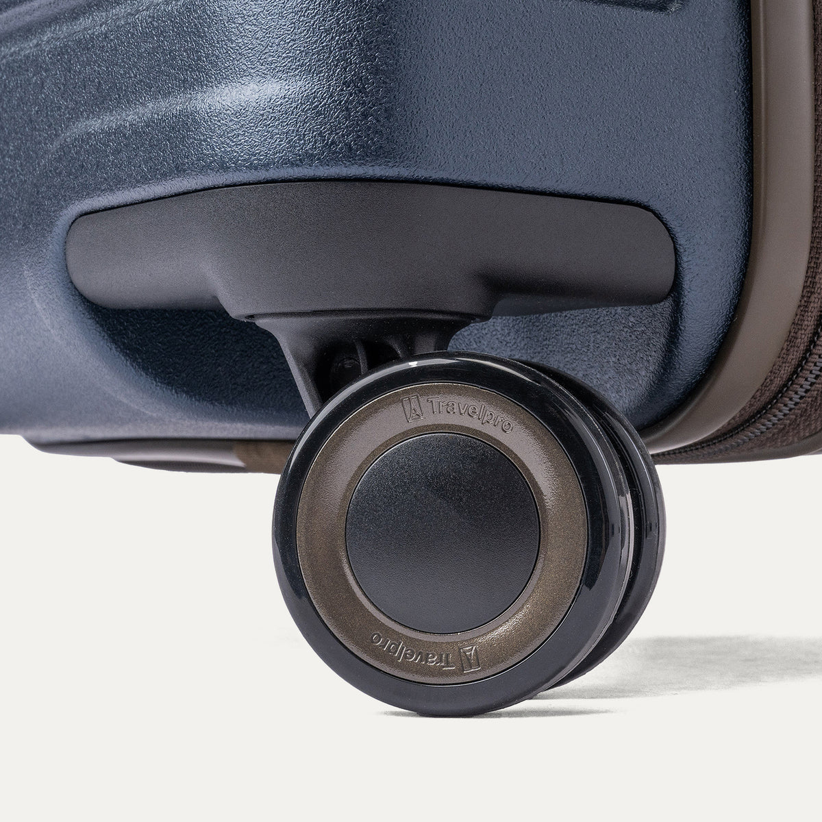 Close-up of a MagnaTrac self-aligning spinner wheel on the Travelpro Platinum Reserve Carry-On Hardside Spinner in Midnight Trail