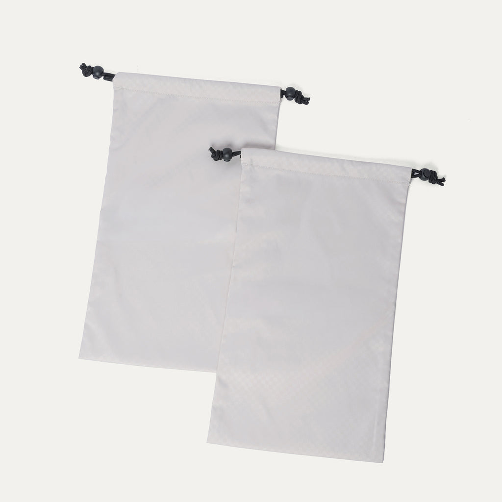 Removable drawstring shoe bags included with the Travelpro Platinum Reserve Medium Check-In Hardside Spinner in Black Dust
