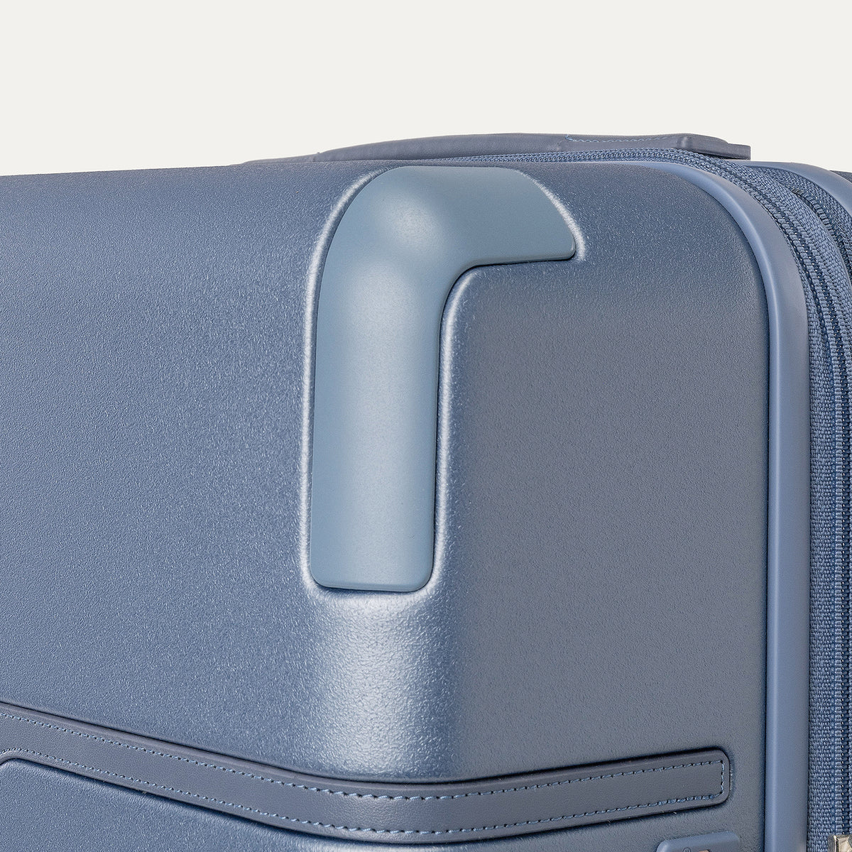 Close-up of the zinc corner armor on the Travelpro Platinum Reserve Medium Check-In Hardside Spinner in Steel Blue