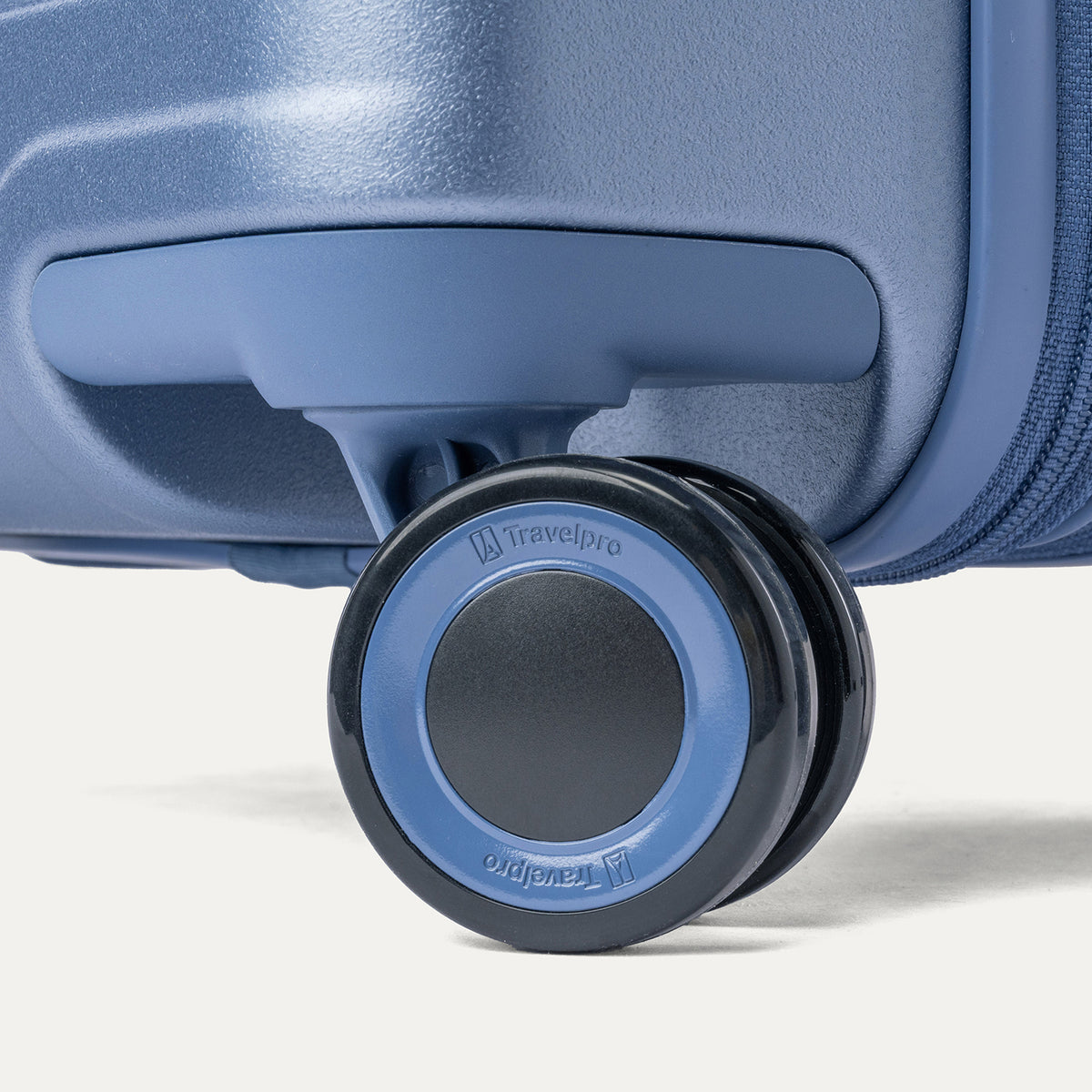 Close-up of a MagnaTrac self-aligning spinner wheel on the Travelpro Platinum Reserve Medium Check-In Hardside Spinner in Steel Blue