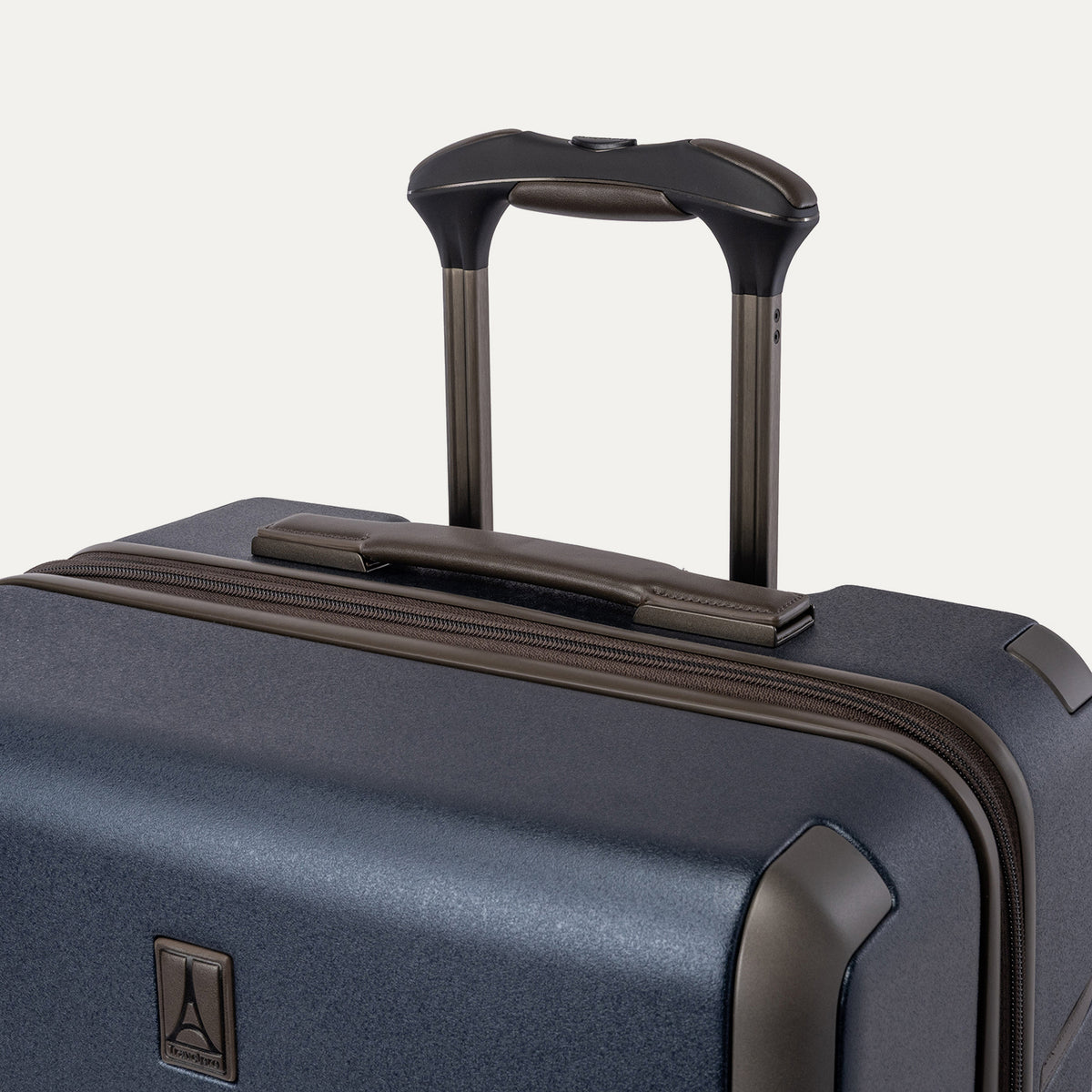 Close-up of the leather-wrapped top handle and PowerScope Lite extension handle on the Travelpro Platinum Reserve Medium Check-In Hardside Spinner in Midnight Trail
