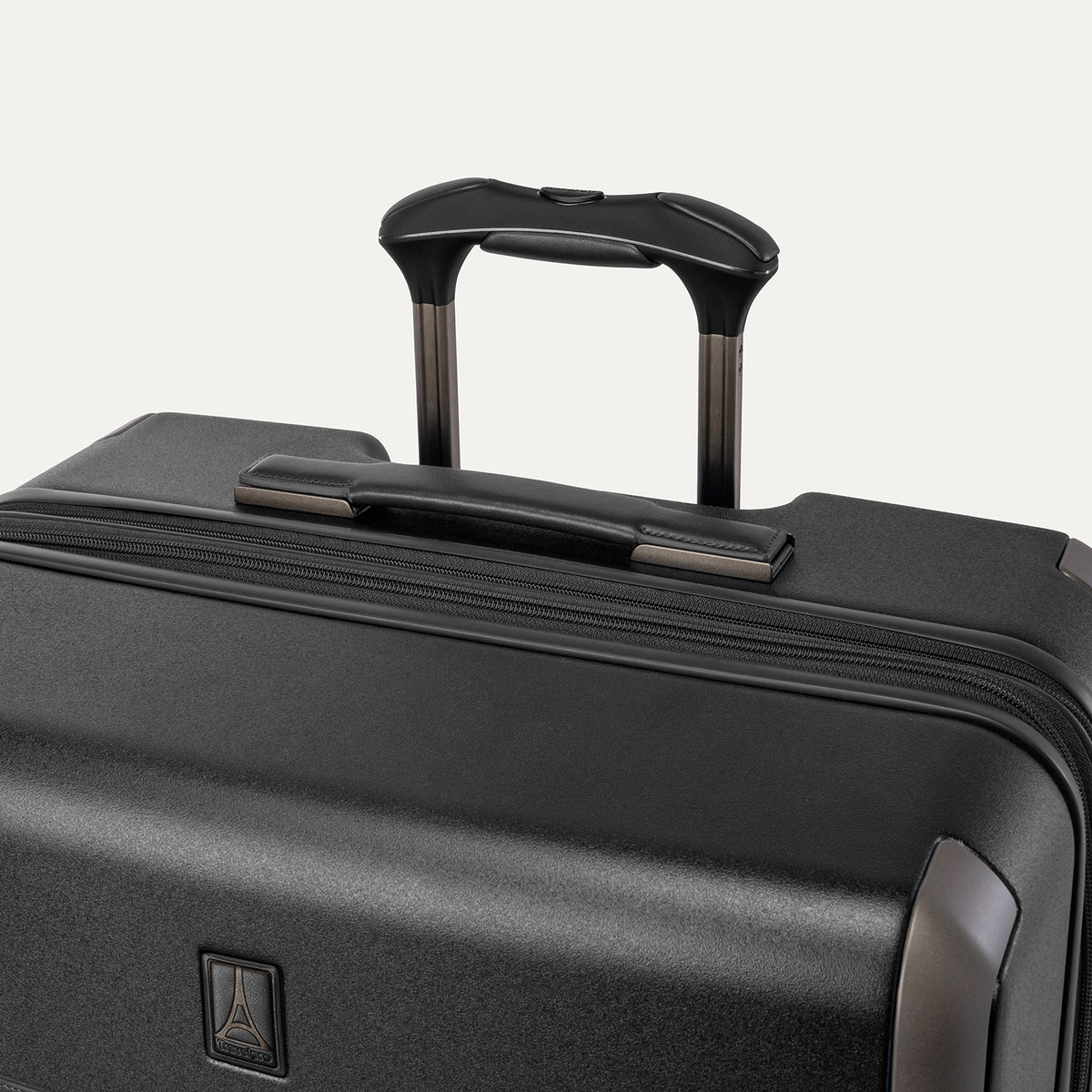 Close-up of the leather-wrapped top handle and PowerScope Lite extension handle on the Travelpro Platinum Reserve Large Check-In Hardside Spinner in Black Dust