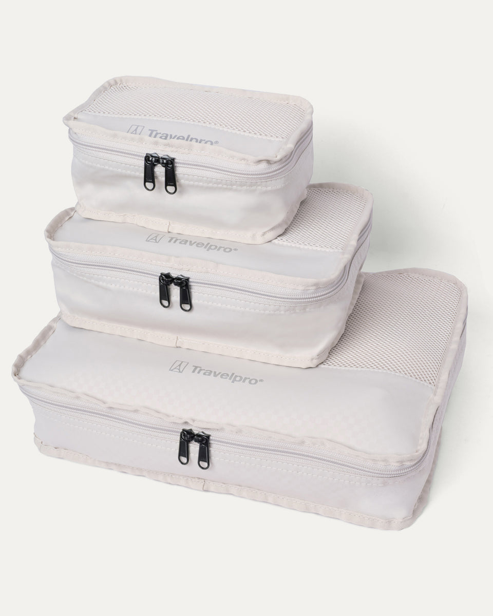 Packing cubes included with the Travelpro Platinum Reserve Large Check-In Hardside Spinner in Black Dust, stacked by size