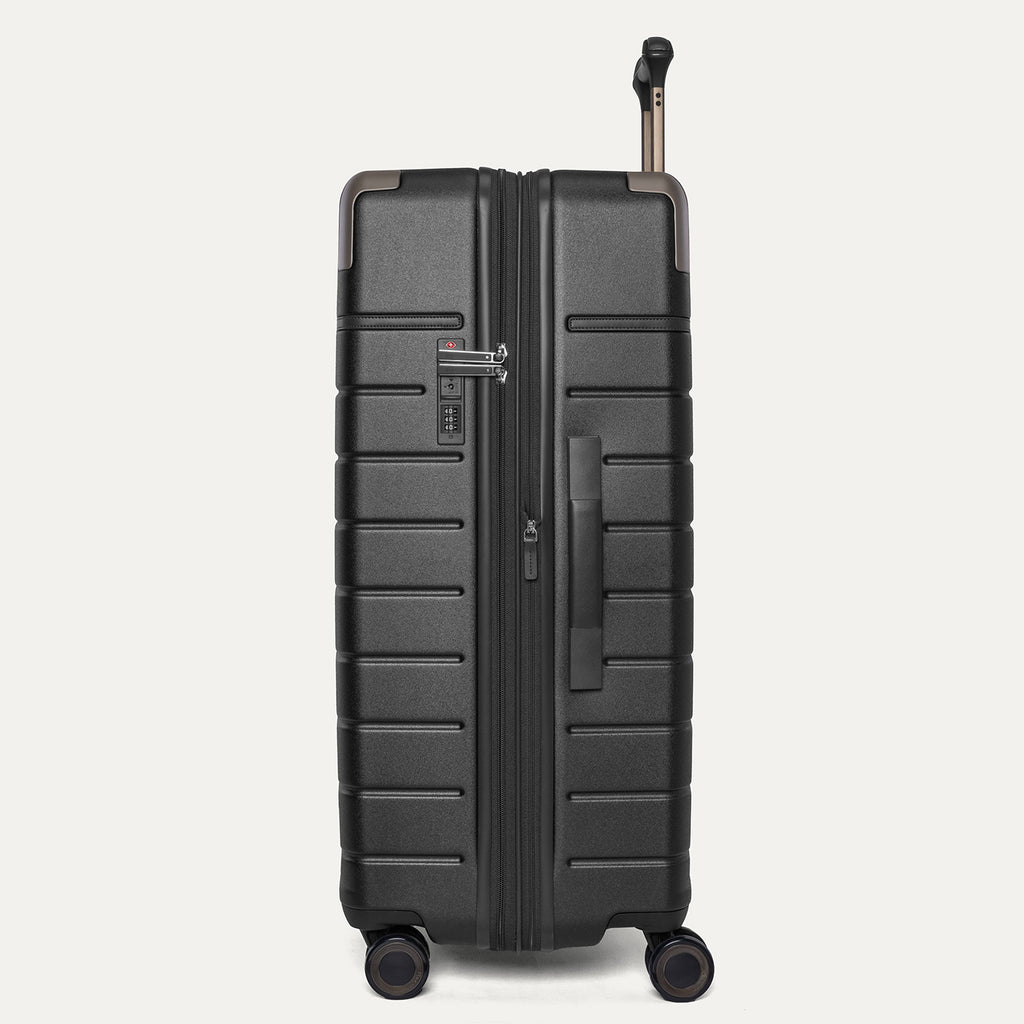 Side profile of the Travelpro Platinum Reserve Large Check-In Hardside Spinner in Black Dust