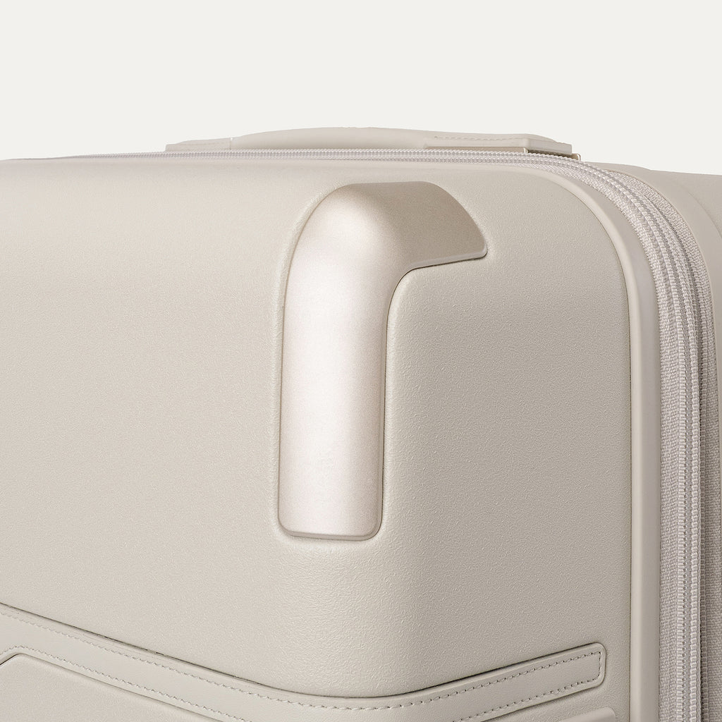 Close-up of the zinc corner armor on the Travelpro Platinum Reserve Large Check-In Hardside Spinner in Sandstone