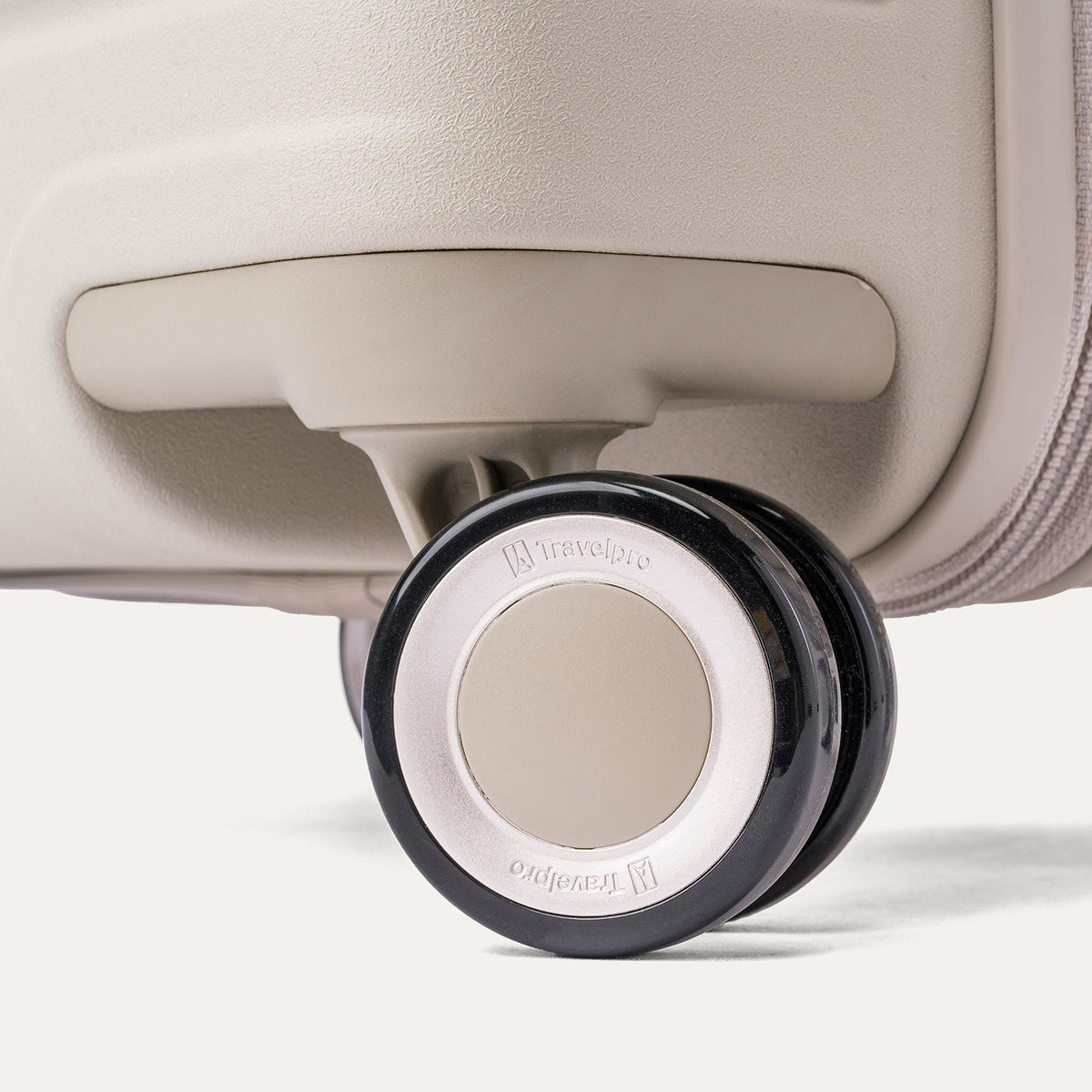 Close-up of a MagnaTrac self-aligning spinner wheel on the Travelpro Platinum Reserve Large Check-In Hardside Spinner in Sandstone