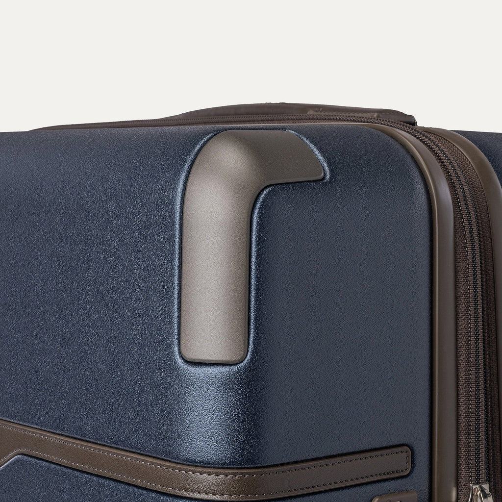 Close-up of the zinc corner armor on the Travelpro Platinum Reserve Large Check-In Hardside Spinner in Midnight Trail