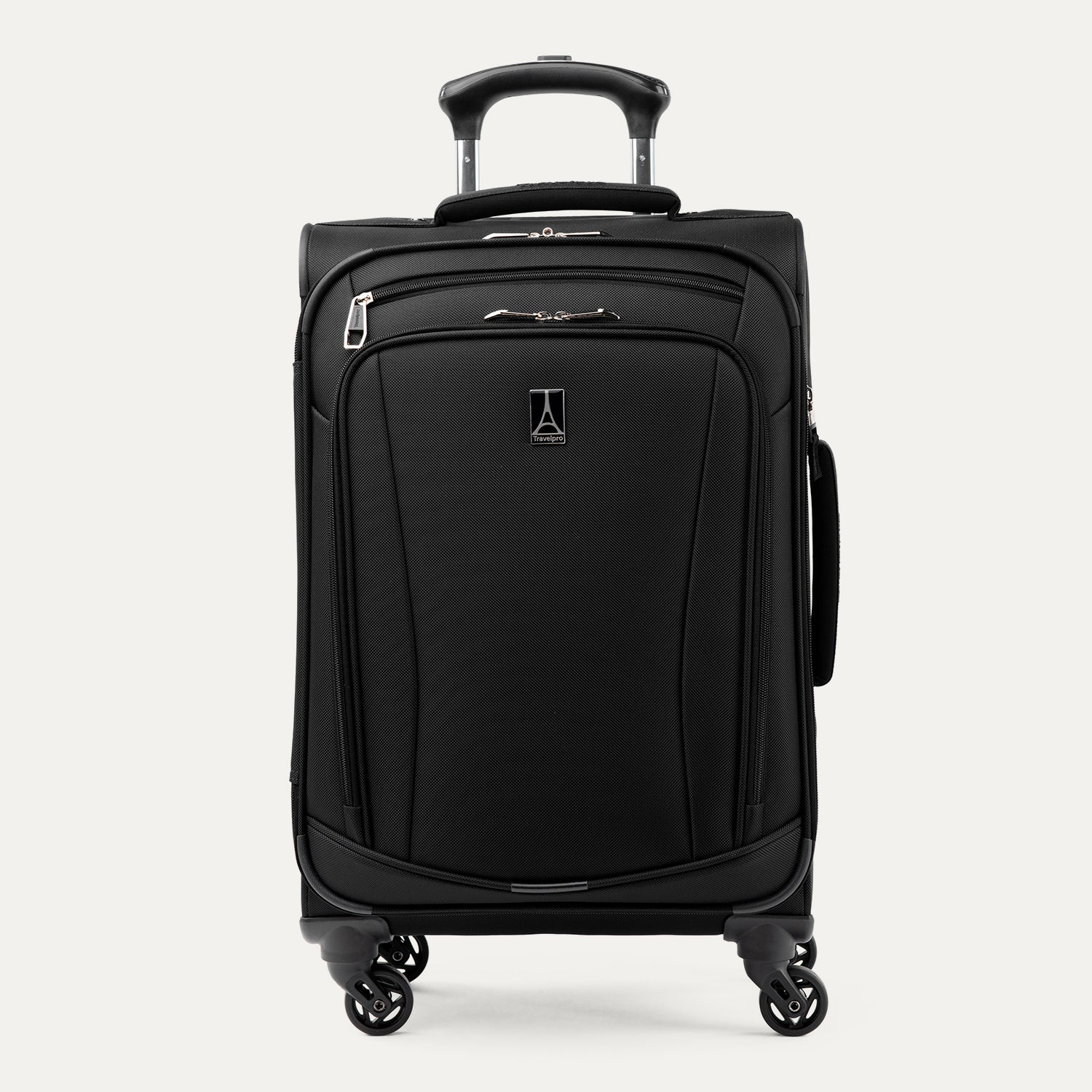Three-quarter front view of the Travelpro Runway Tote / Carry-on Luggage Set in Black, showing the softside carry-on spinner featuring an extended telescopic handle, a zippered front pocket with the Travelpro logo badge, and multi-directional spinner wheels against a clean off-white background.