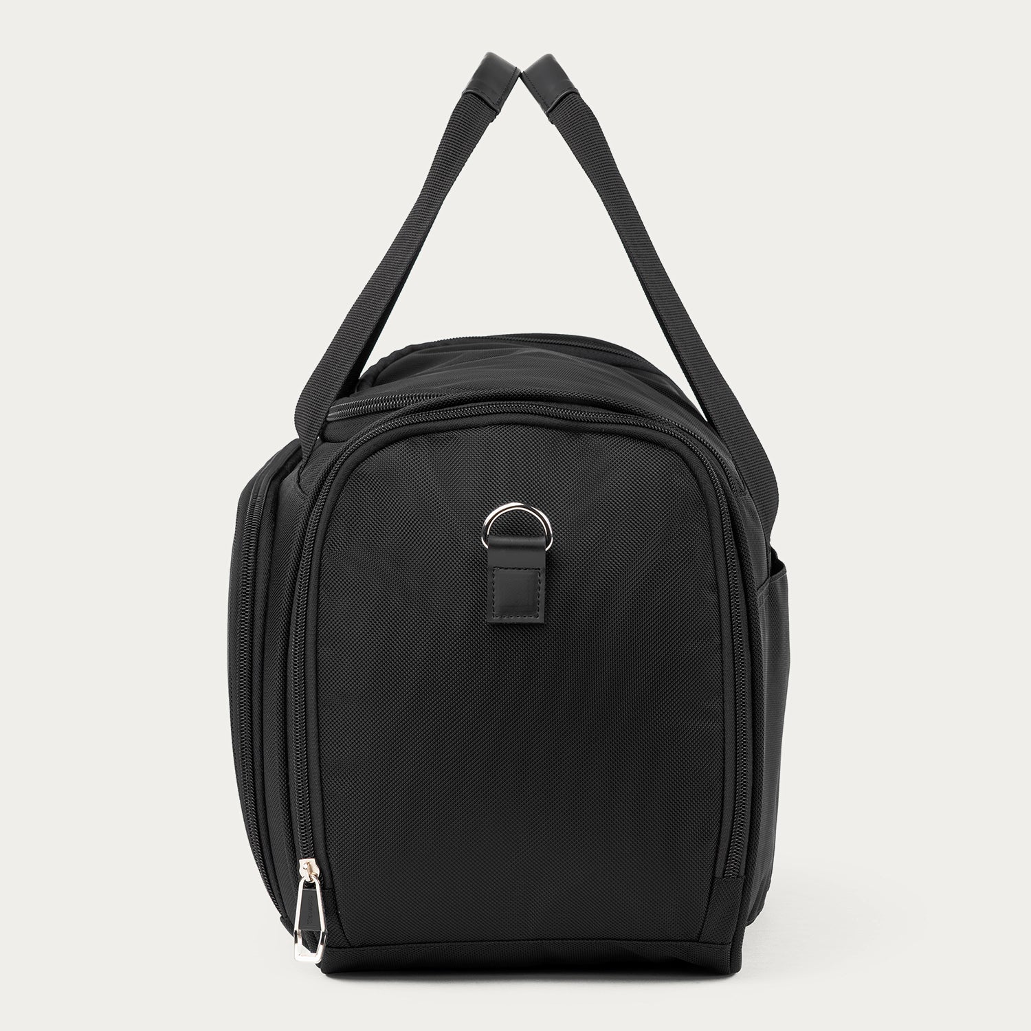 A black nylon Travelpro Runway Tote with a top zipper, side pockets, and a silver metal D-ring accent, shown against a light gray background.