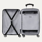 Open black hardside spinner suitcase showing interior with cross straps on one side and a zippered mesh divider pocket on the other.