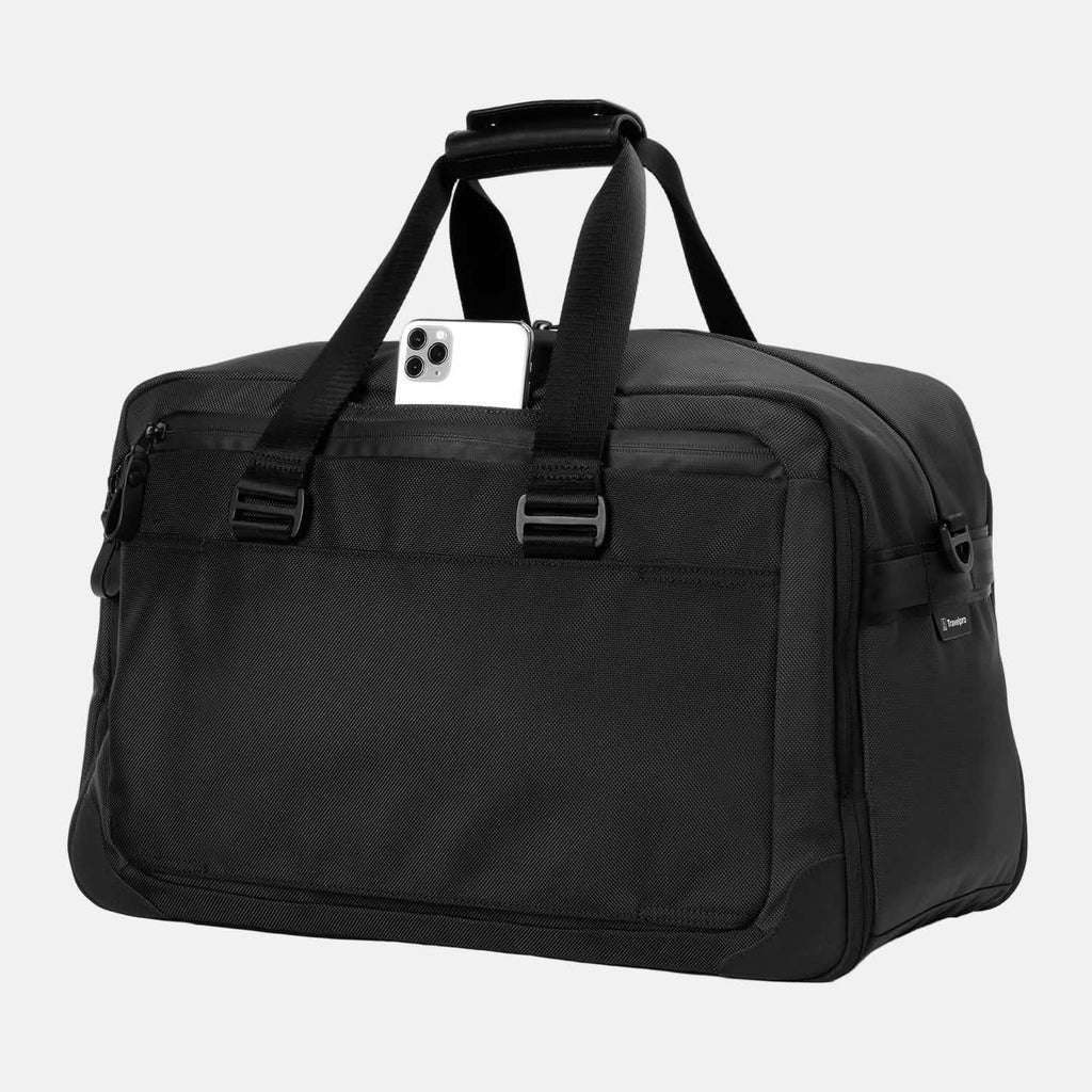 Slanted front view of Travelpro Altitude Double Expansion Duffel in Jet Black with phone in QuickSlip Pocket, D-ring, and top handles.
