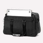 Back view of Travelpro Altitude Double Expansion Duffel in Jet Black with laptop partially tucked in rear zippered pocket.
