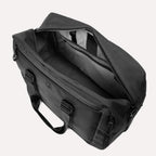 Slanted top view of Travelpro Altitude Double Expansion Duffel in Jet Black with open main compartment and interior pockets.
