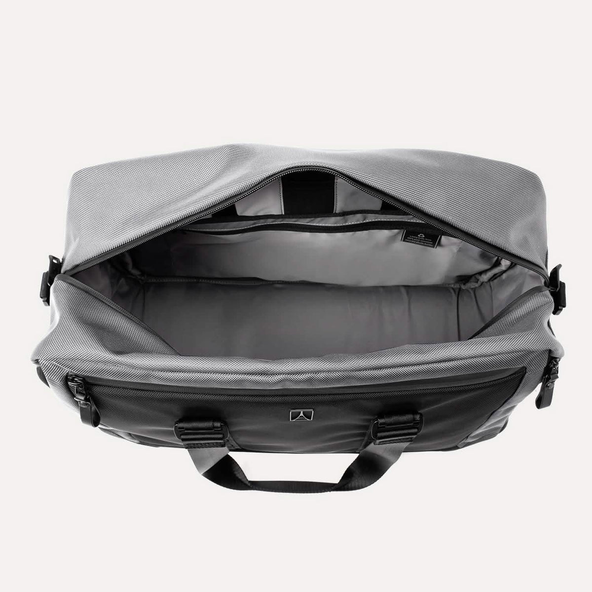  Travelpro® Altitude™ Double Expansion Duffel in Falcon Grey shown from above with the top zipper open, revealing a spacious main compartment
