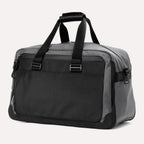 Slanted rear view of the Travelpro® Altitude™ Double Expansion Duffel in Falcon Grey, showing the closed rear pocket and dual carry handles.