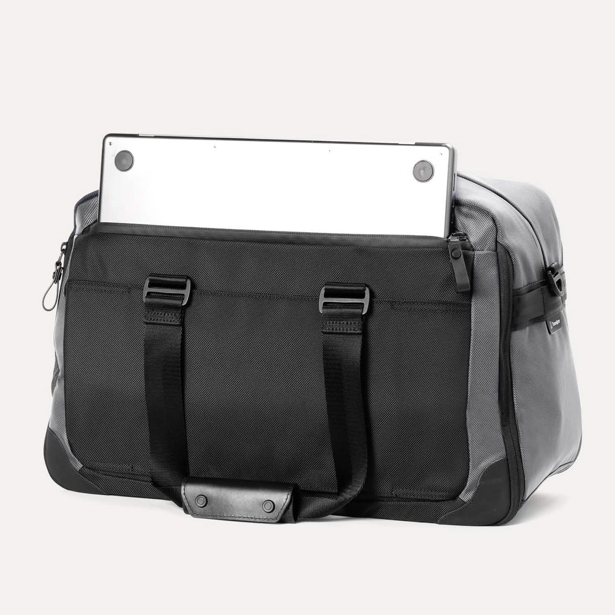 Rear view of the Travelpro® Altitude™ Double Expansion Duffel in Falcon Grey, showing an exterior zip pocket with a laptop partially inserted.







Ask ChatGPT
