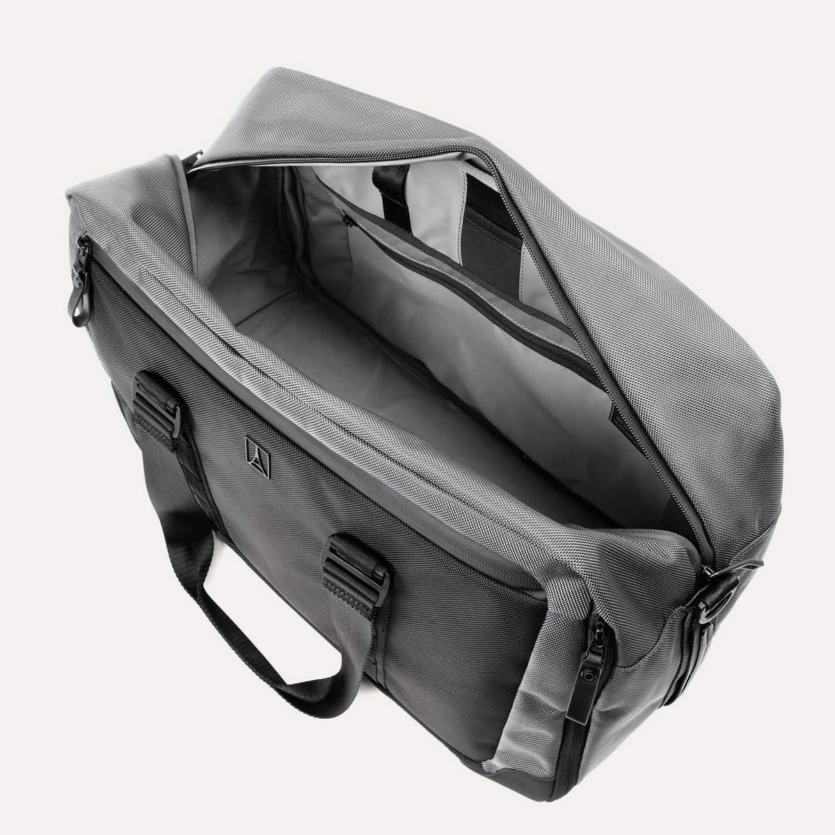 Top view of Travelpro Altitude Double Expansion Duffel in falcon grey, unzipped to show spacious interior and organizational pockets.
