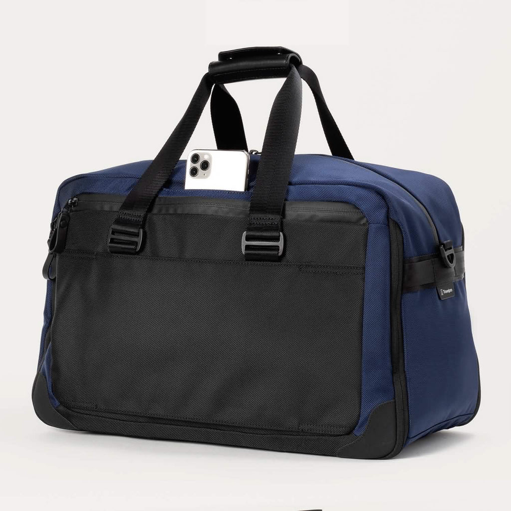 Rear view of the Travelpro® Altitude™ Double Expansion Duffel in Aviator Navy/Black, featuring a quick-access pocket with a smartphone partially inserted and sturdy dual handles.
