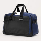 Rear view of the Travelpro® Altitude™ Double Expansion Duffel in Aviator Navy/Black, featuring a quick-access pocket with a smartphone partially inserted and sturdy dual handles.
