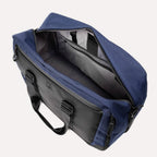 Open top view of the Travelpro® Altitude™ Double Expansion Duffel in Aviator Navy/Black, showcasing a spacious main compartment with an interior zippered pocket and dual padded handles