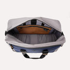 Open top view of the Travelpro® Altitude™ Double Expansion Duffel in Stellar Navy/Grey, showing the spacious main compartment with an interior zippered pocket and divider panel.