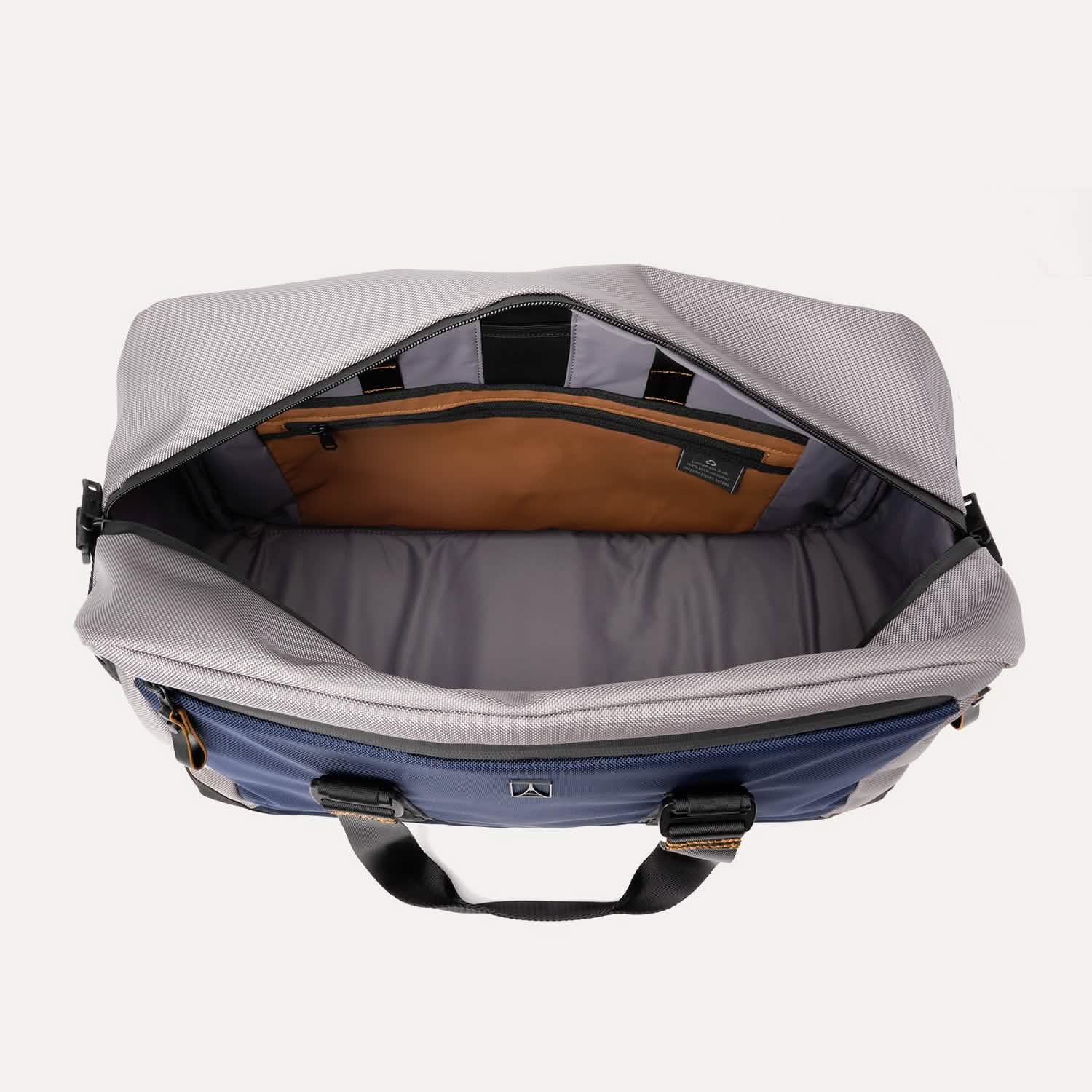 Open top view of the Travelpro® Altitude™ Double Expansion Duffel in Stellar Navy/Grey, showing the spacious main compartment with an interior zippered pocket and divider panel.