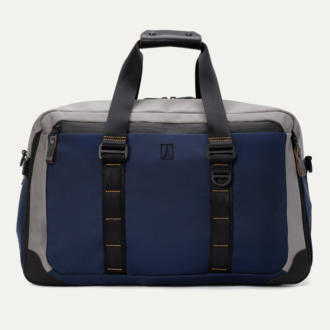Rear view of the Travelpro® Altitude™ Double Expansion Duffel in Stellar Navy/Grey, featuring dual carry handles with reinforced stitching and a large exterior slip pocket holding a smartphone.
