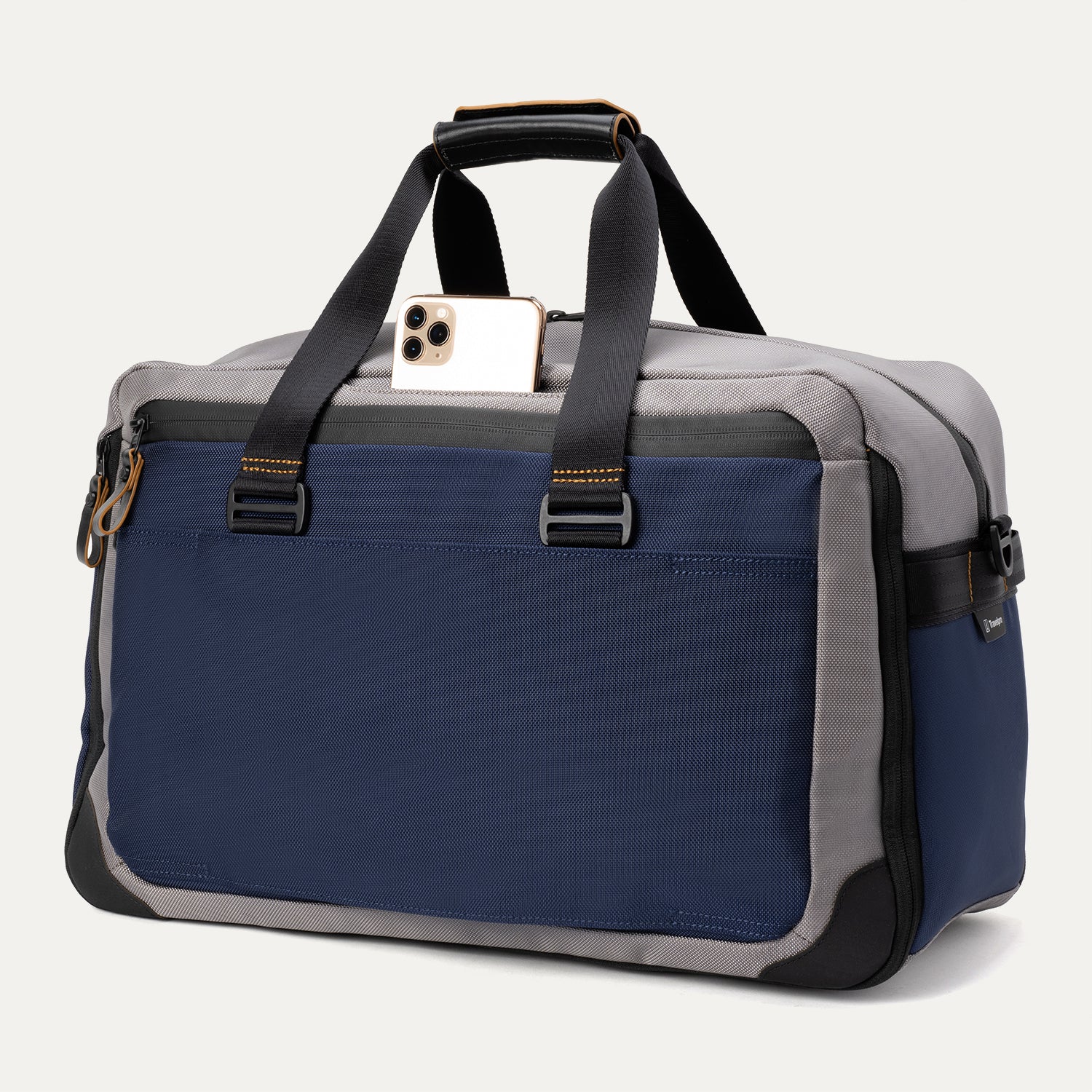Rear view of the Travelpro® Altitude™ Double Expansion Duffel in Stellar Navy/Grey, featuring dual carry handles with reinforced stitching and a large exterior slip pocket holding a smartphone.
