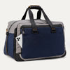 Slanted rear view of the Travelpro® Altitude™ Double Expansion Duffel in Stellar Navy/Grey, featuring dual carry handles with reinforced stitching and a exterior slip pocket holding a smartphone.
