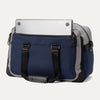 Rear view of the Travelpro® Altitude™ Double Expansion Duffel in Stellar Navy/Grey, featuring dual carry handles with reinforced stitching and an exterior slip pocket holding a laptop.
